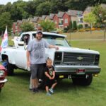 The owner and his son posing with their Ford Truck